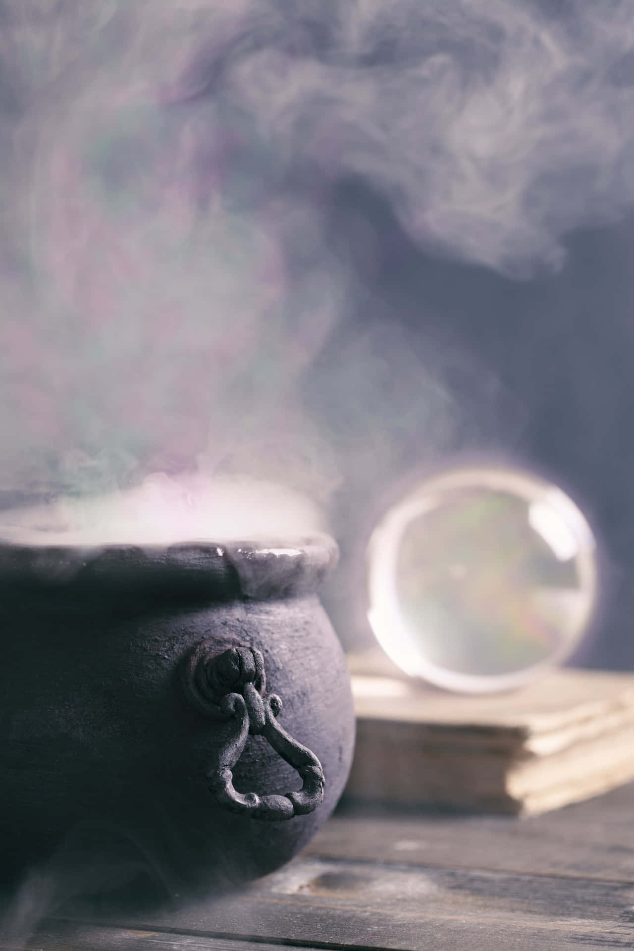 A mysterious bubbling cauldron in a dark setting Wallpaper