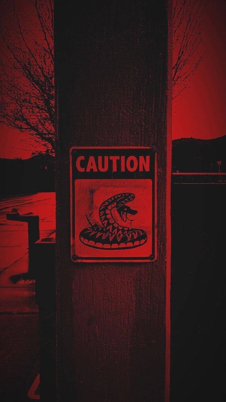 Caution Under Dark Red Sky Wallpaper