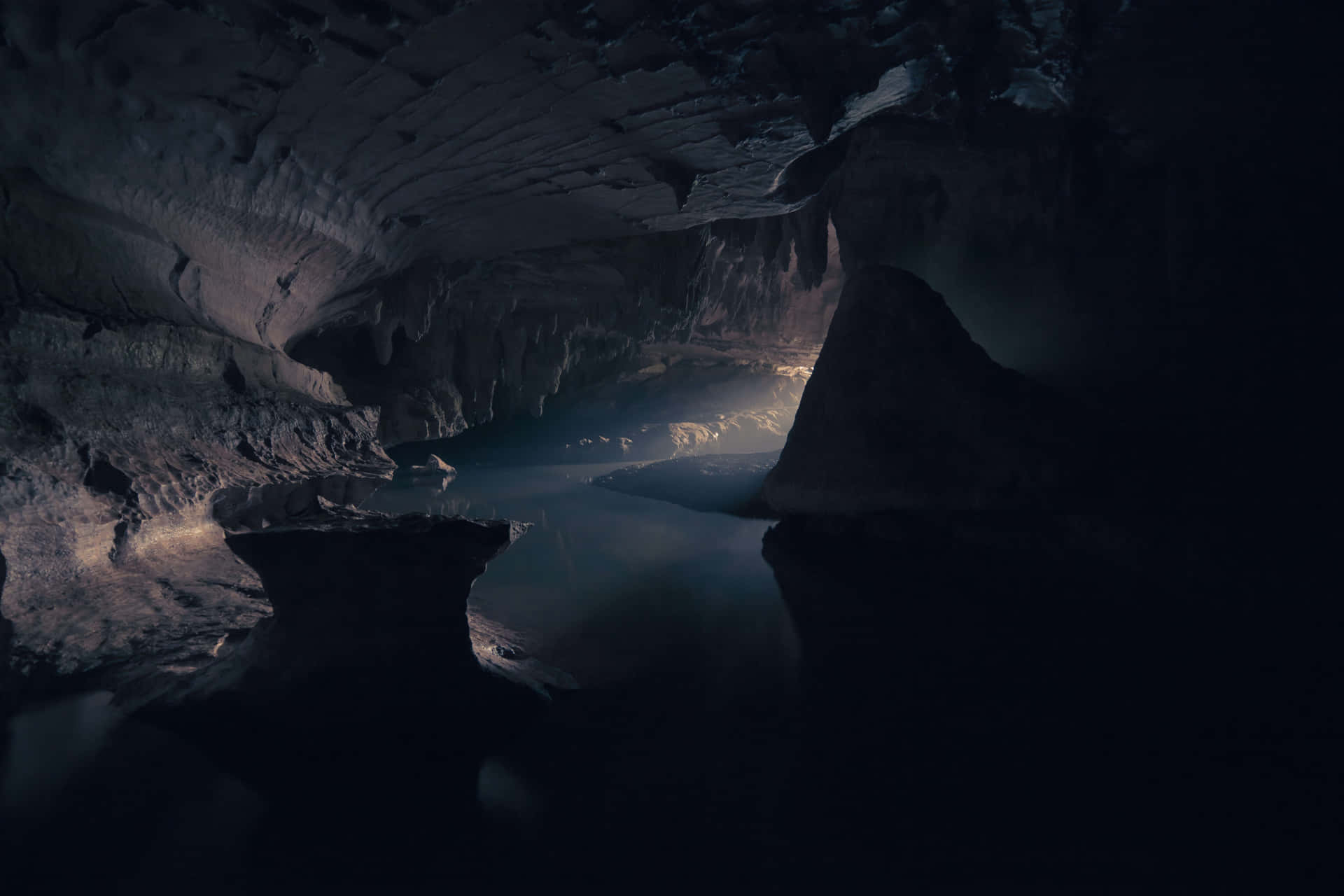 A Dark Cave With Water In It