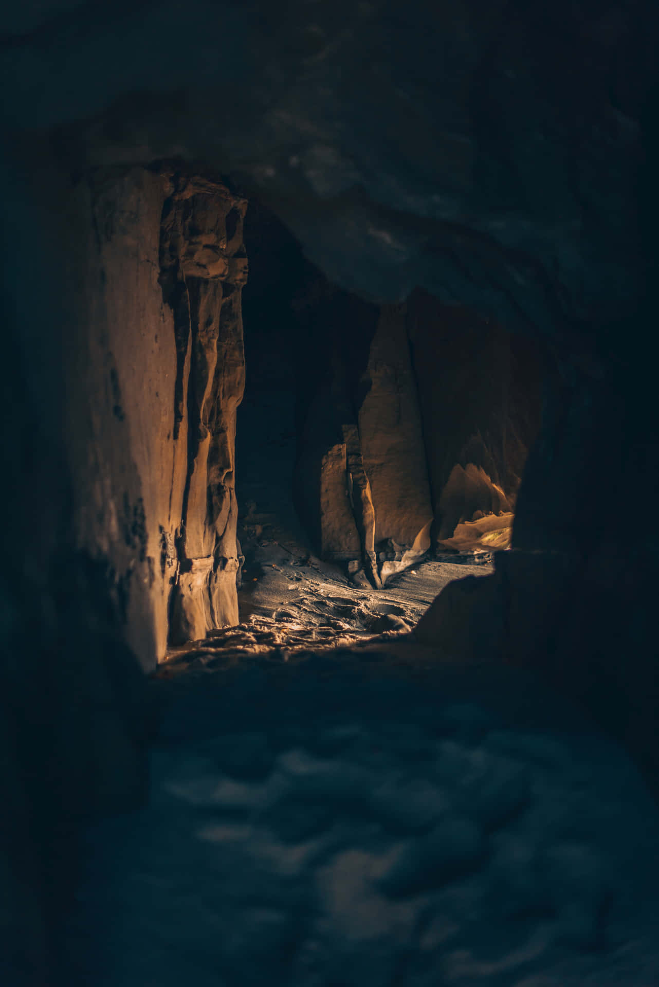A Cave With A Light Shining Through It