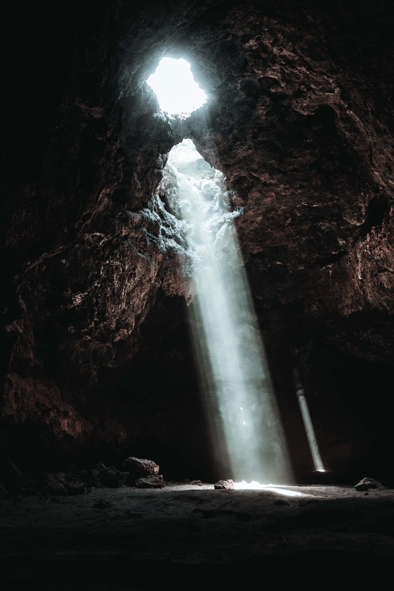 A breathtaking peek inside of a stunning beach-side cave