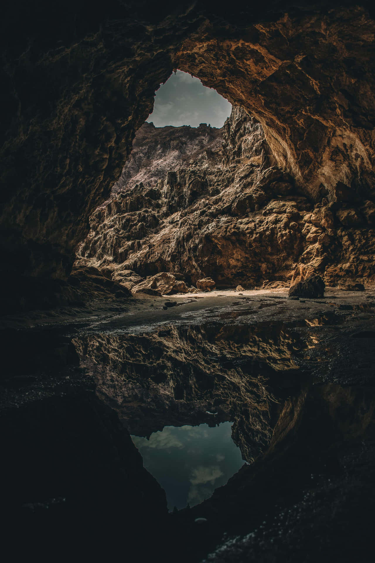 A Cave With A Reflection In The Water