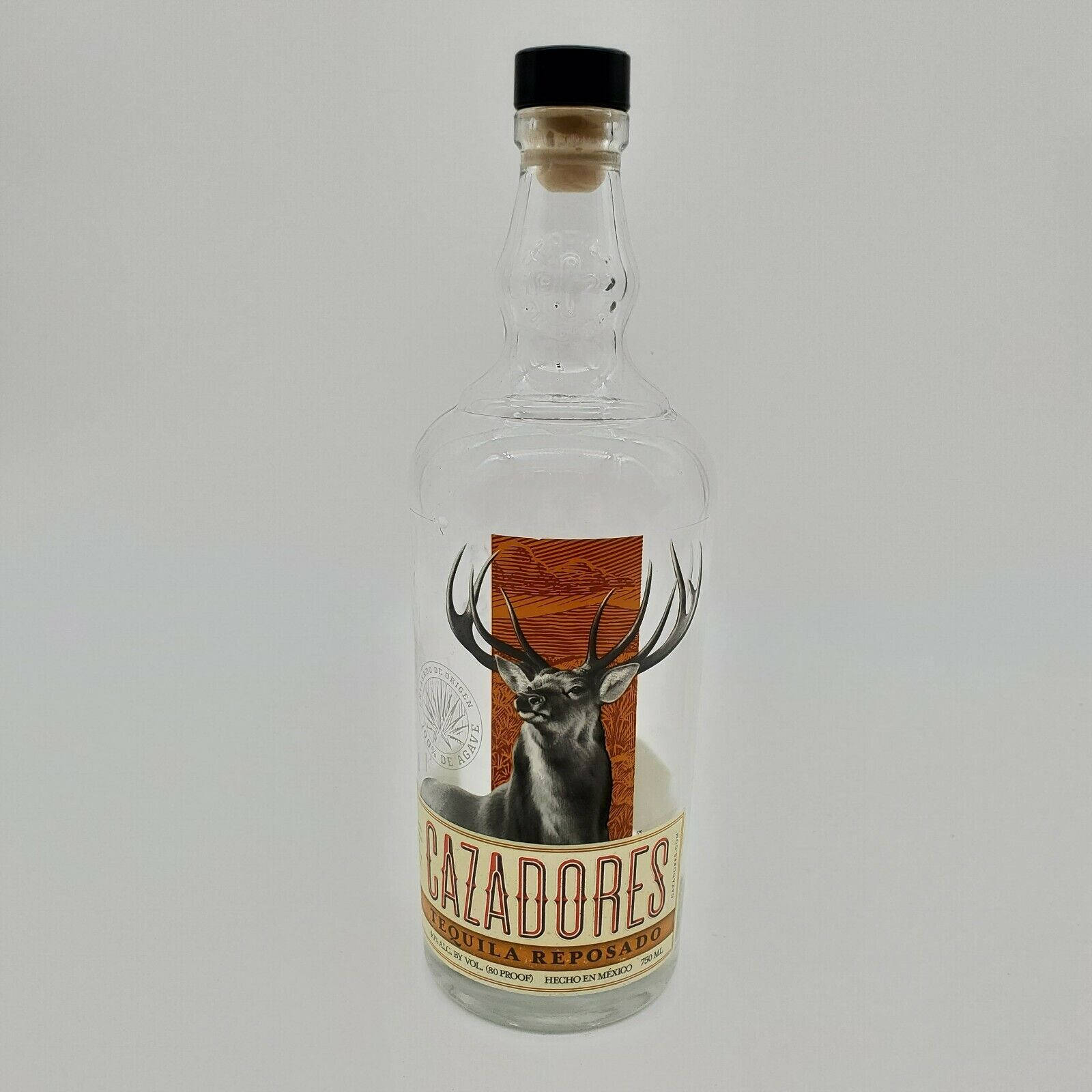 An empty bottle of Cazadores Tequila Reposado depicts the refined taste and history of Mexican beverages. Wallpaper