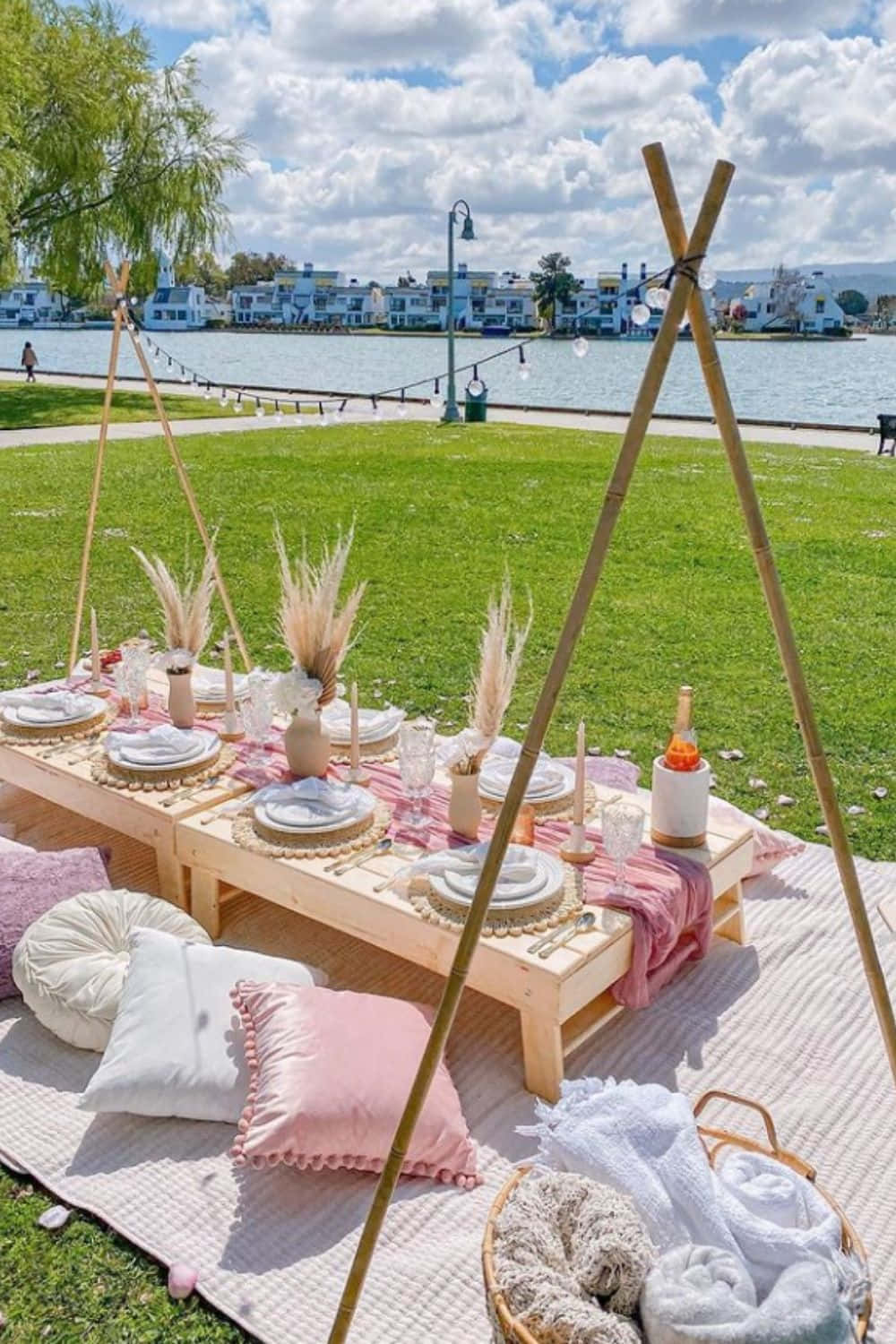 A Picnic Table Set Up In The Grass Near The Water
