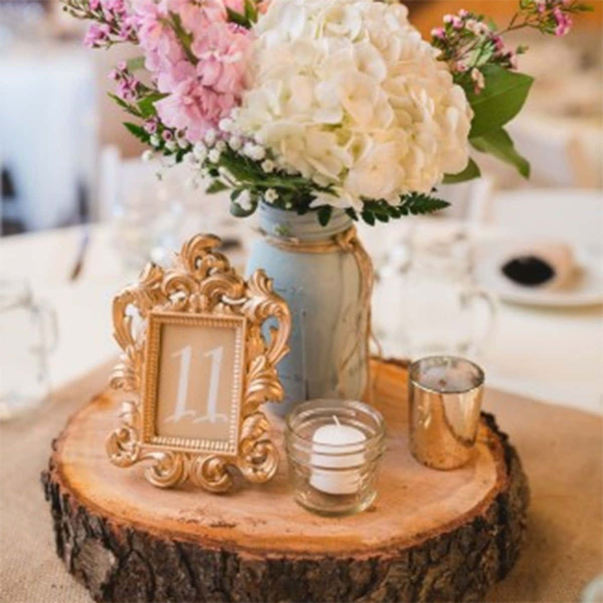 Brightly-colored table centerpiece with autumnal leaves and vintage jars. Wallpaper