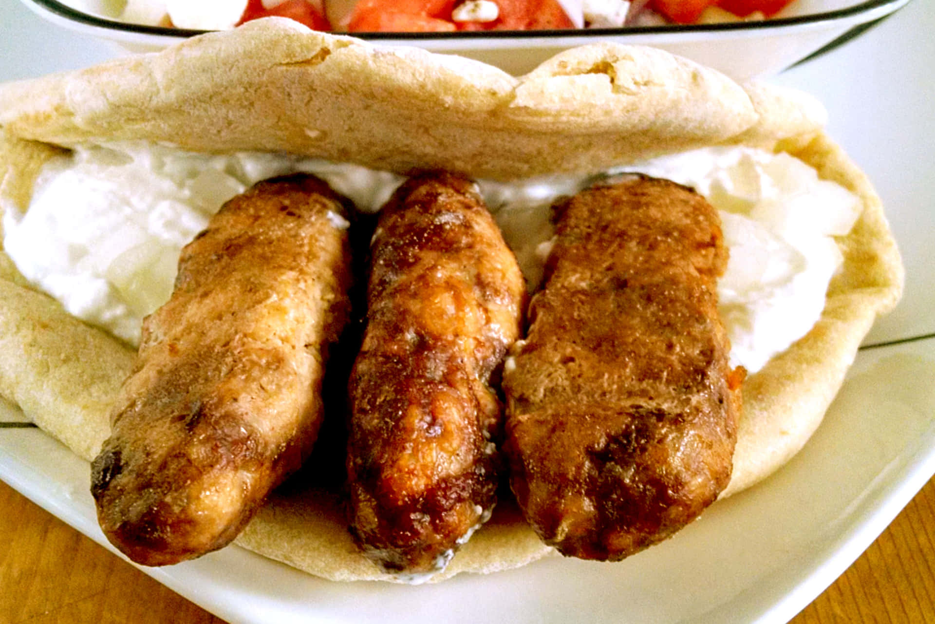 Ćevapipita Sandwich Is A Traditional Bosnian Dish Consisting Of Grilled Minced Meat Served In A Pita Bread With Various Condiments And Toppings. Wallpaper