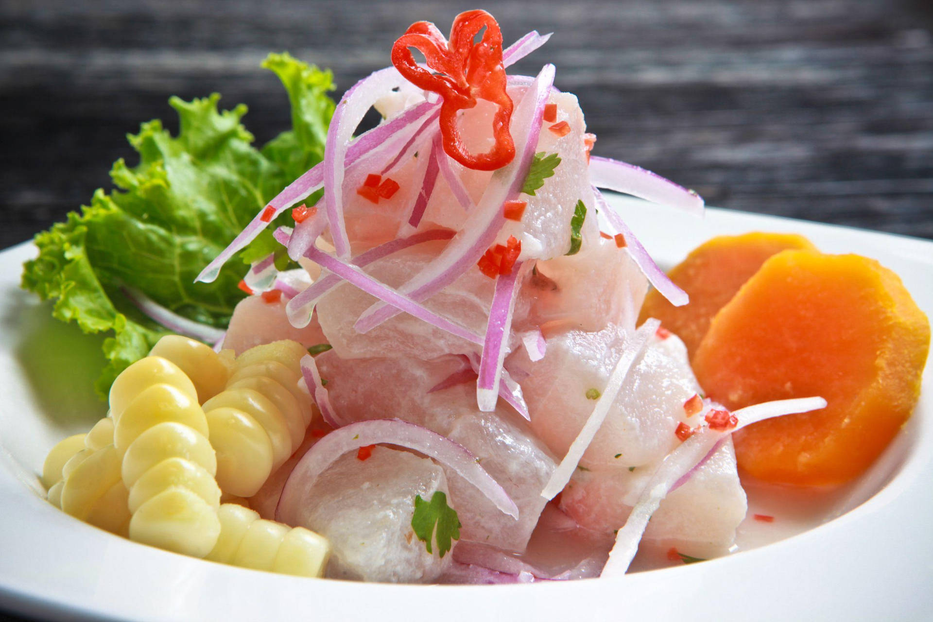 Delightful Ceviche Dish Served with Corn, Onions, and Sweet Potatoes Wallpaper