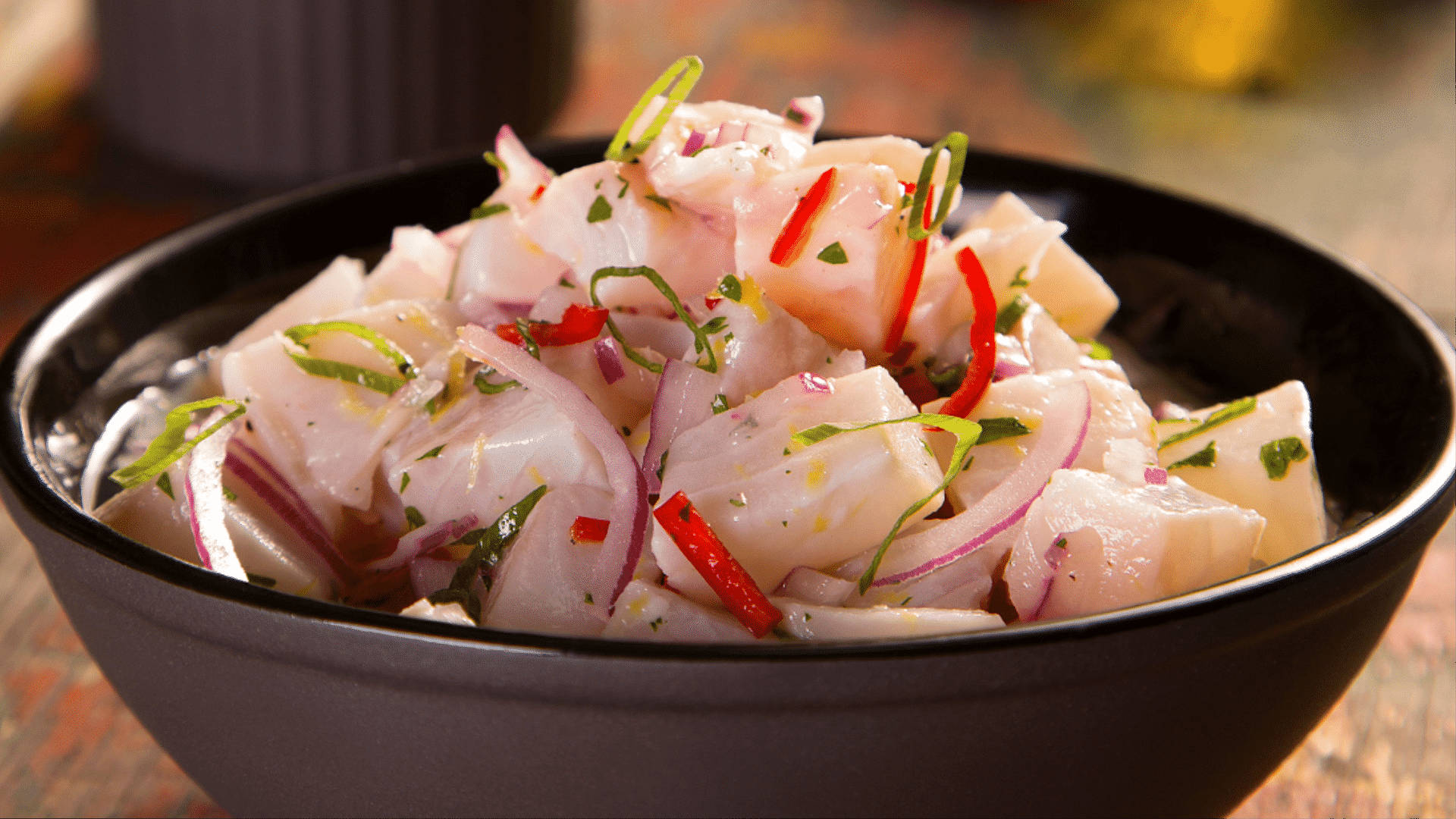 Ceviche With Onions In Black Bowl Wallpaper