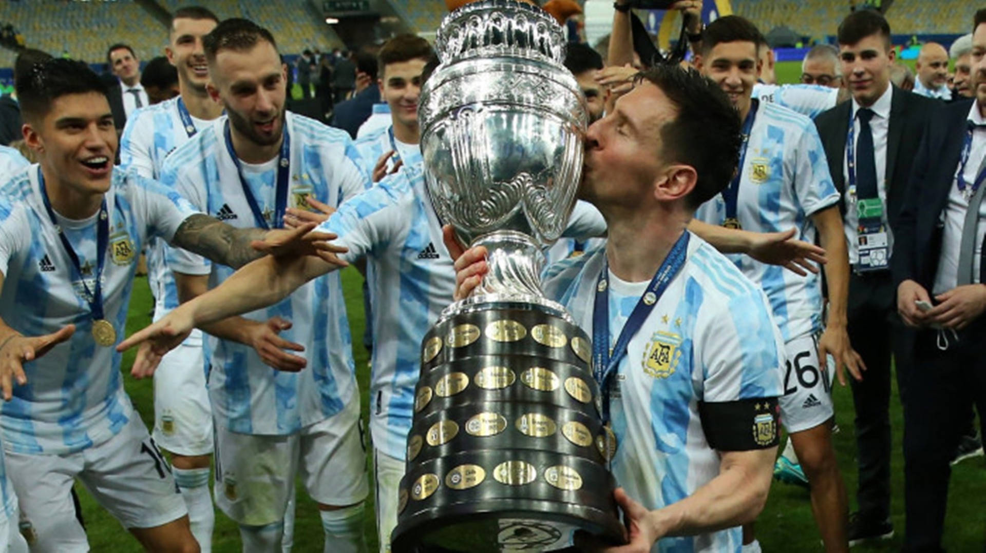 "Lionel Messi Celebrating with the Championship Trophy Representing Argentina" Wallpaper