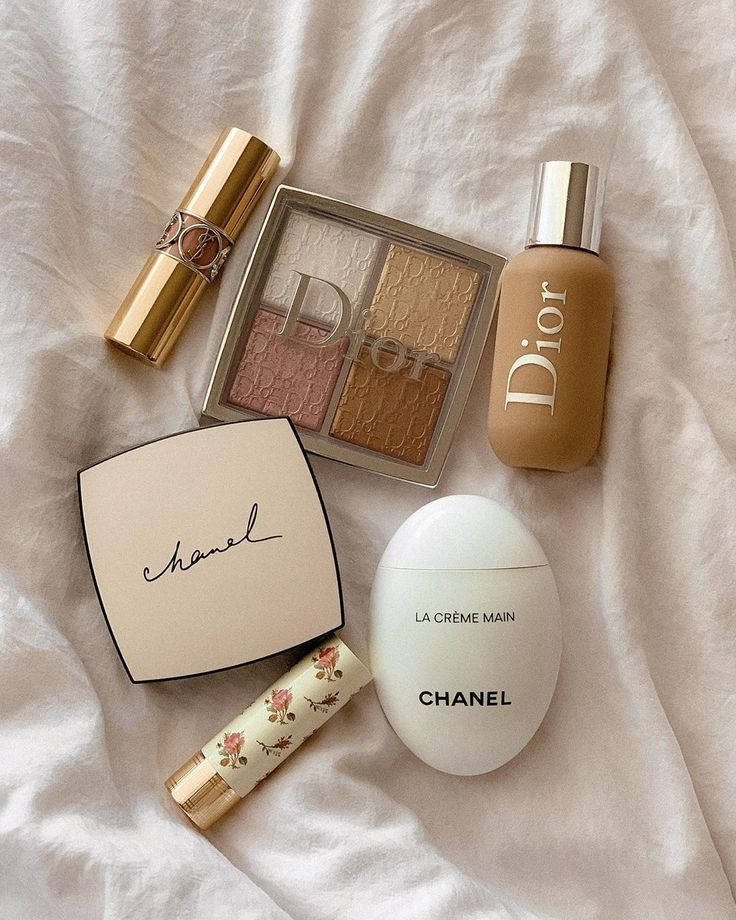 A White Bed With Cosmetics And A Chanel Bag Wallpaper
