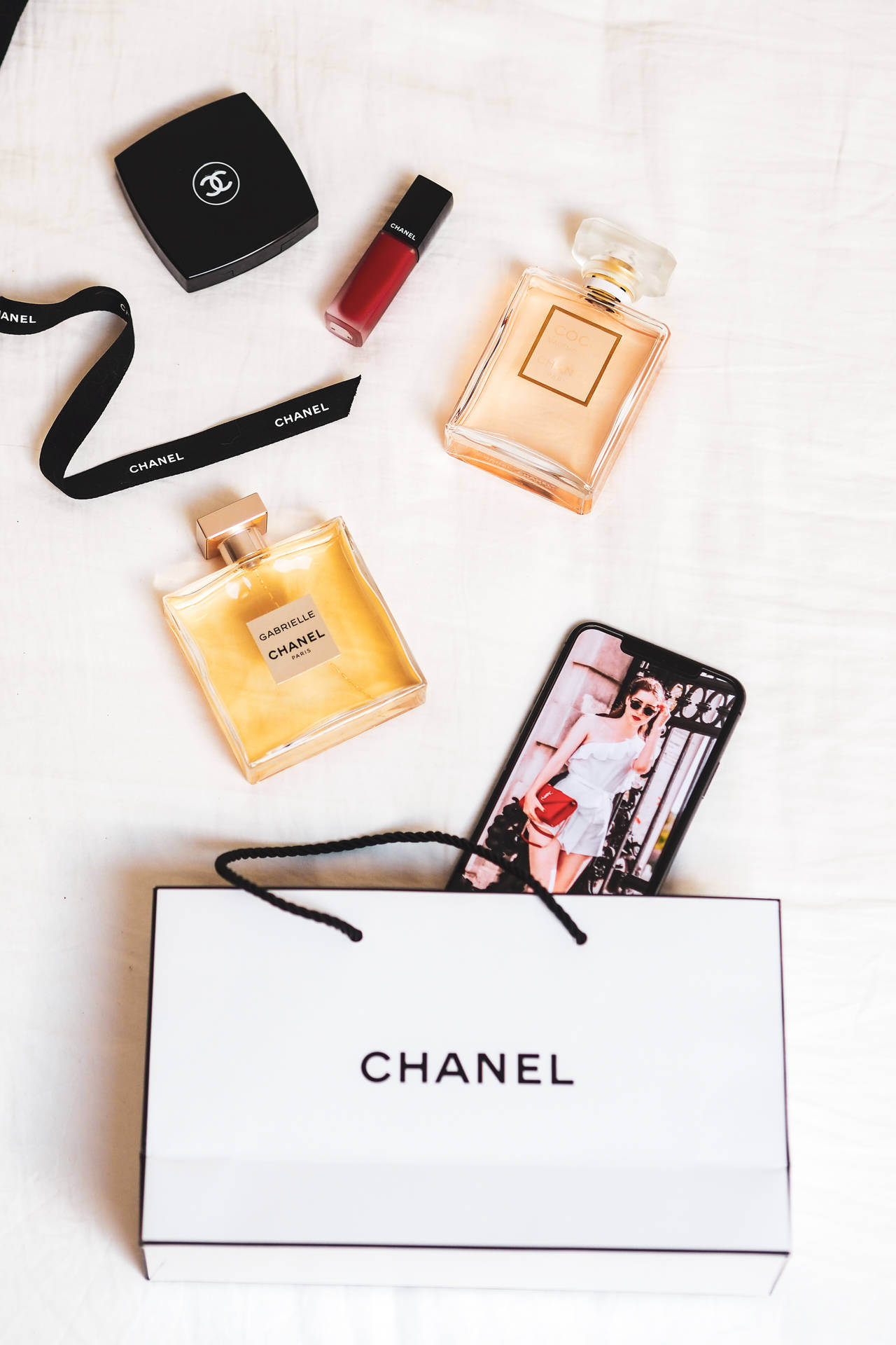 Chanel Aesthetic Products On Bed Background