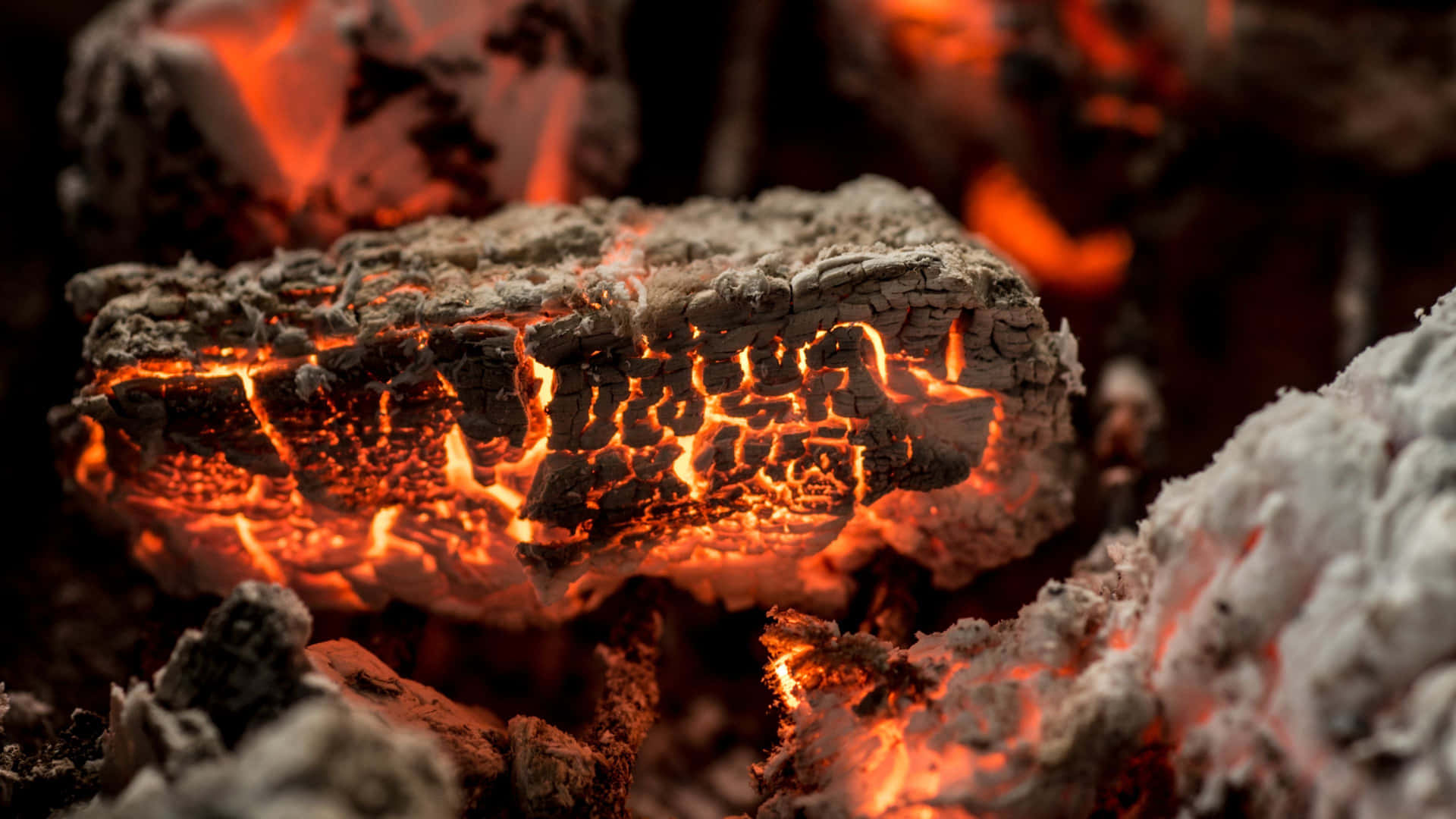 A Close Up Of A Fire With Coals And Fire