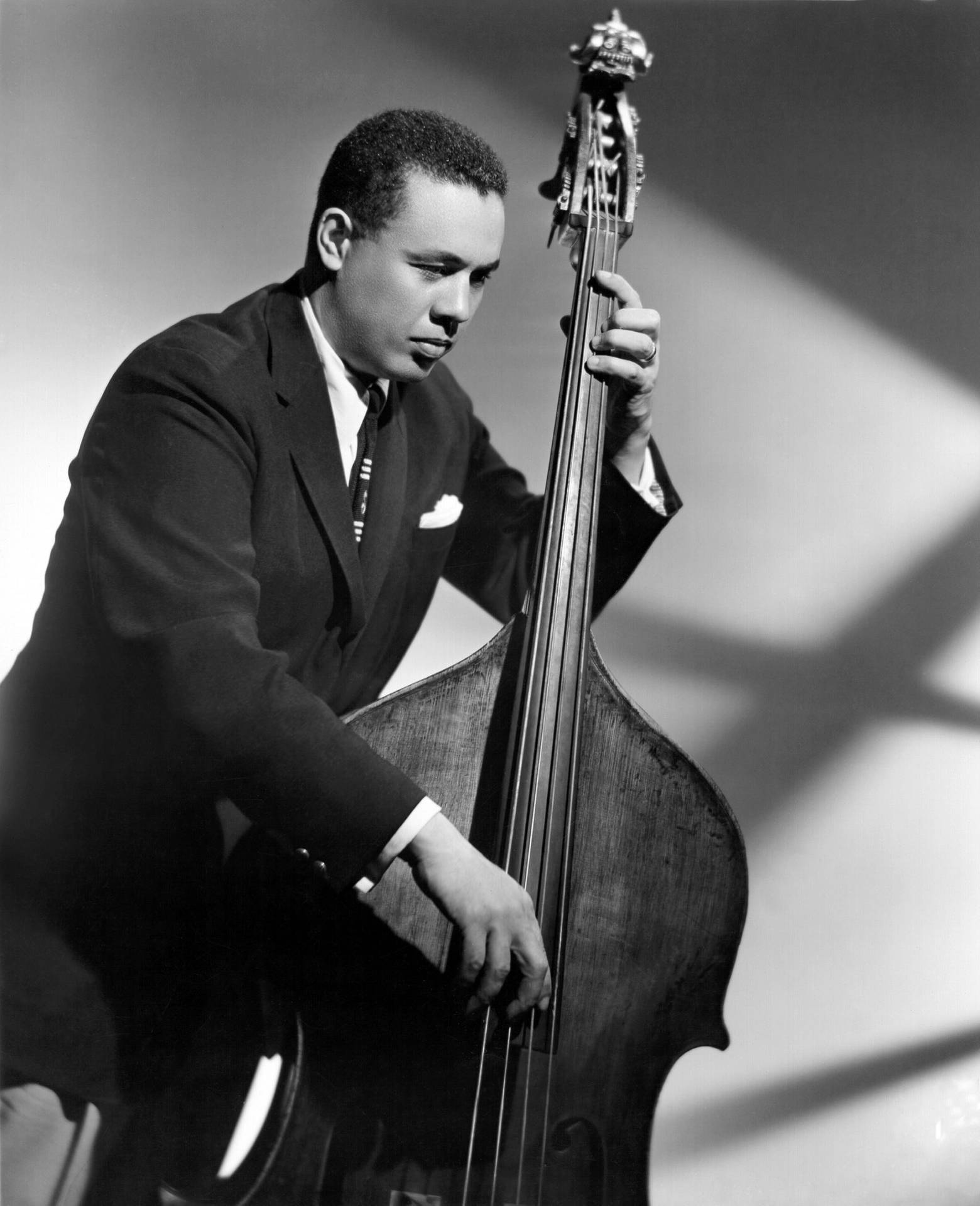 Caption: Charles Mingus, The Jazz Legend in Black and White Wallpaper