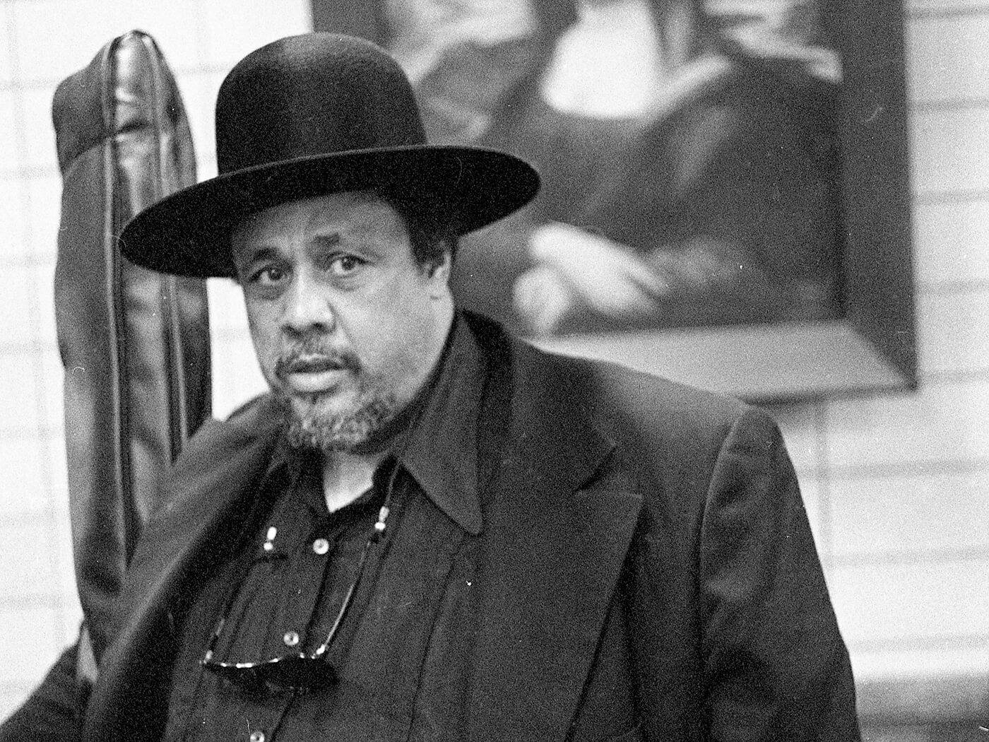 Charles Mingus Donning Priest Hat And Suit Wallpaper