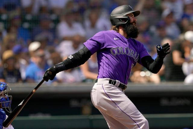 Charlie Blackmon in action, swinging his bat during a game. Wallpaper