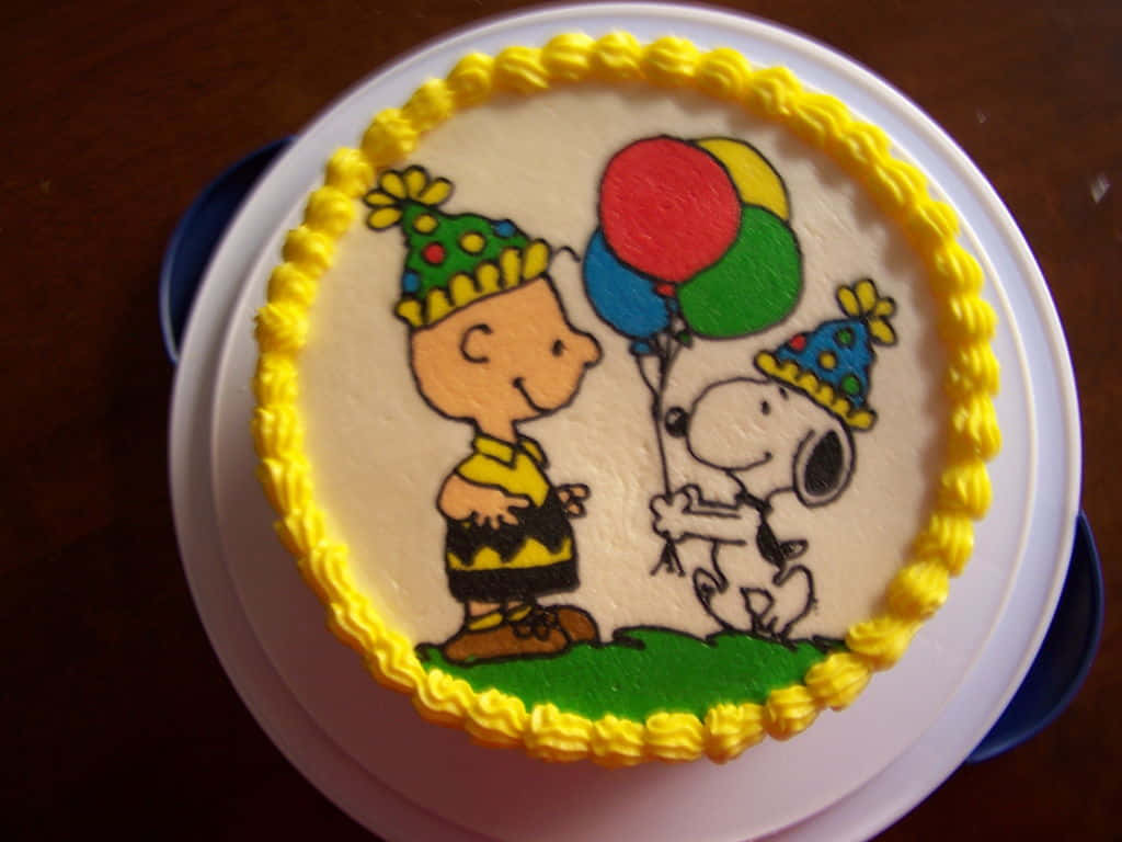 En fødselsdagskage med Charlie Brown og Snoopy på det. Wallpaper