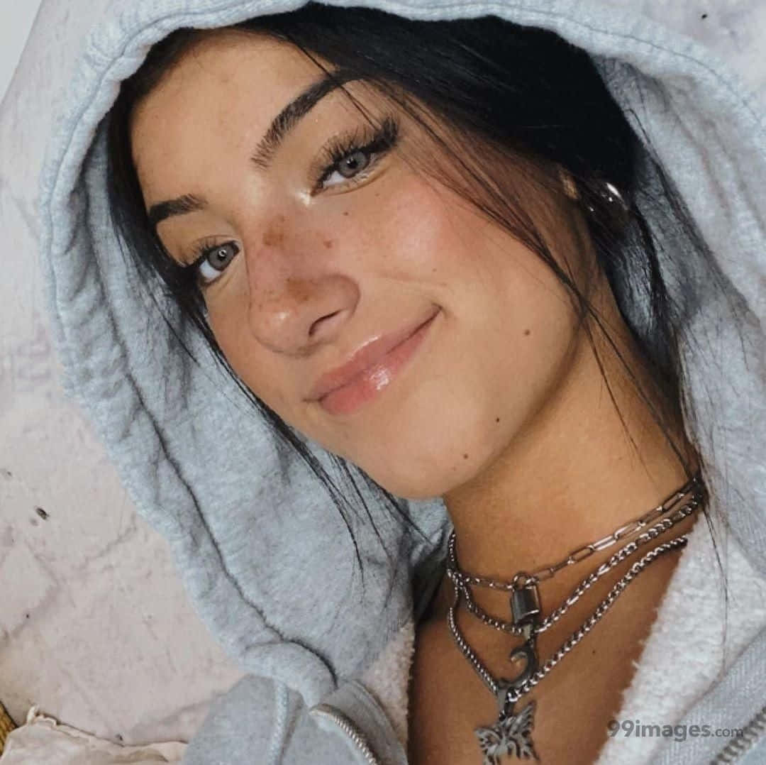 En pige i en grå hættetrøje med en halskæde Wallpaper