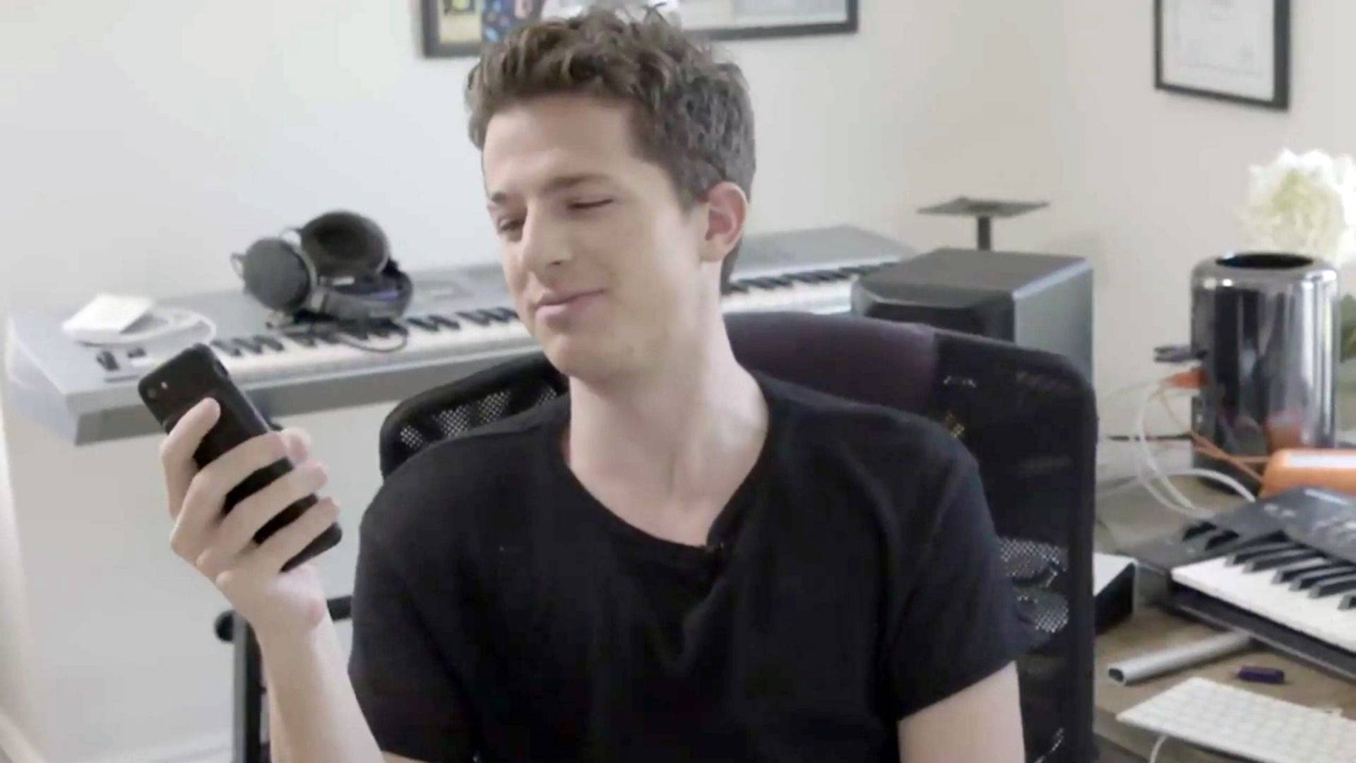Charlie Puth Using Cellphone Background