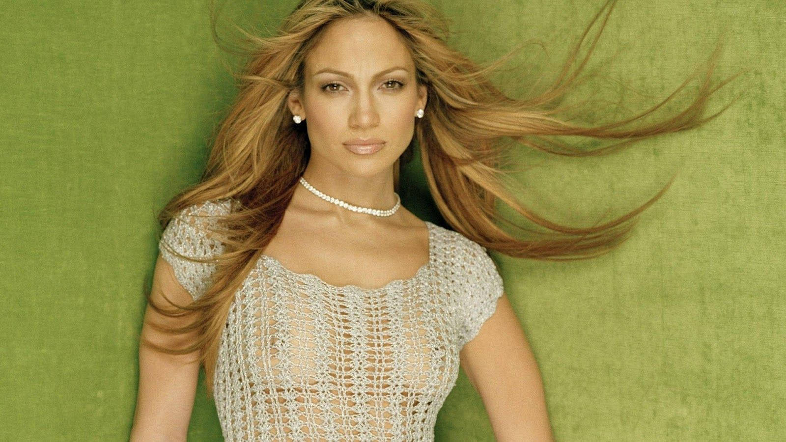 Charming Jennifer Lopez In See Through Top Background
