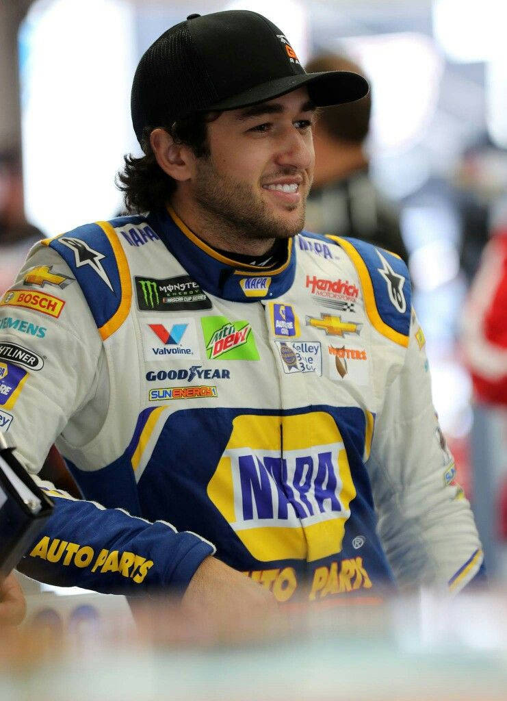 Chase Elliott Triumphantly Standing Before a Blurry Crowd Wallpaper
