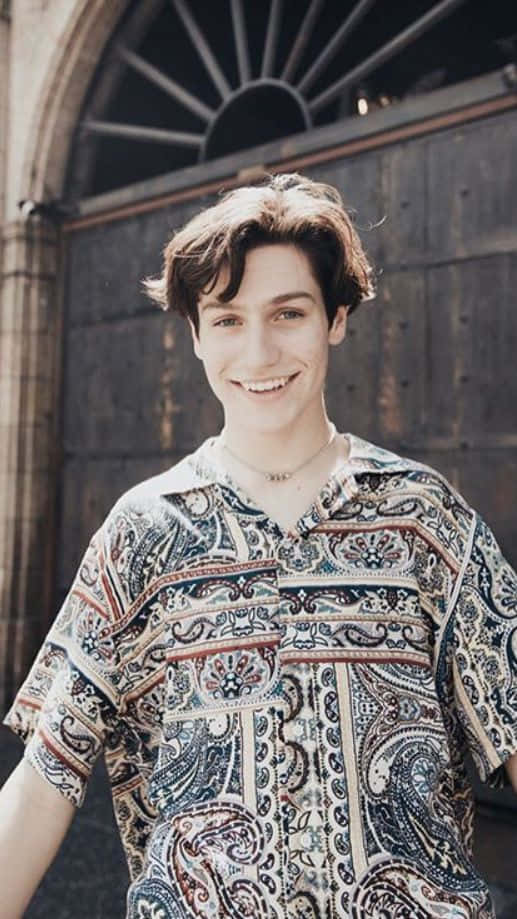 A Young Man Wearing A Paisley Shirt Wallpaper