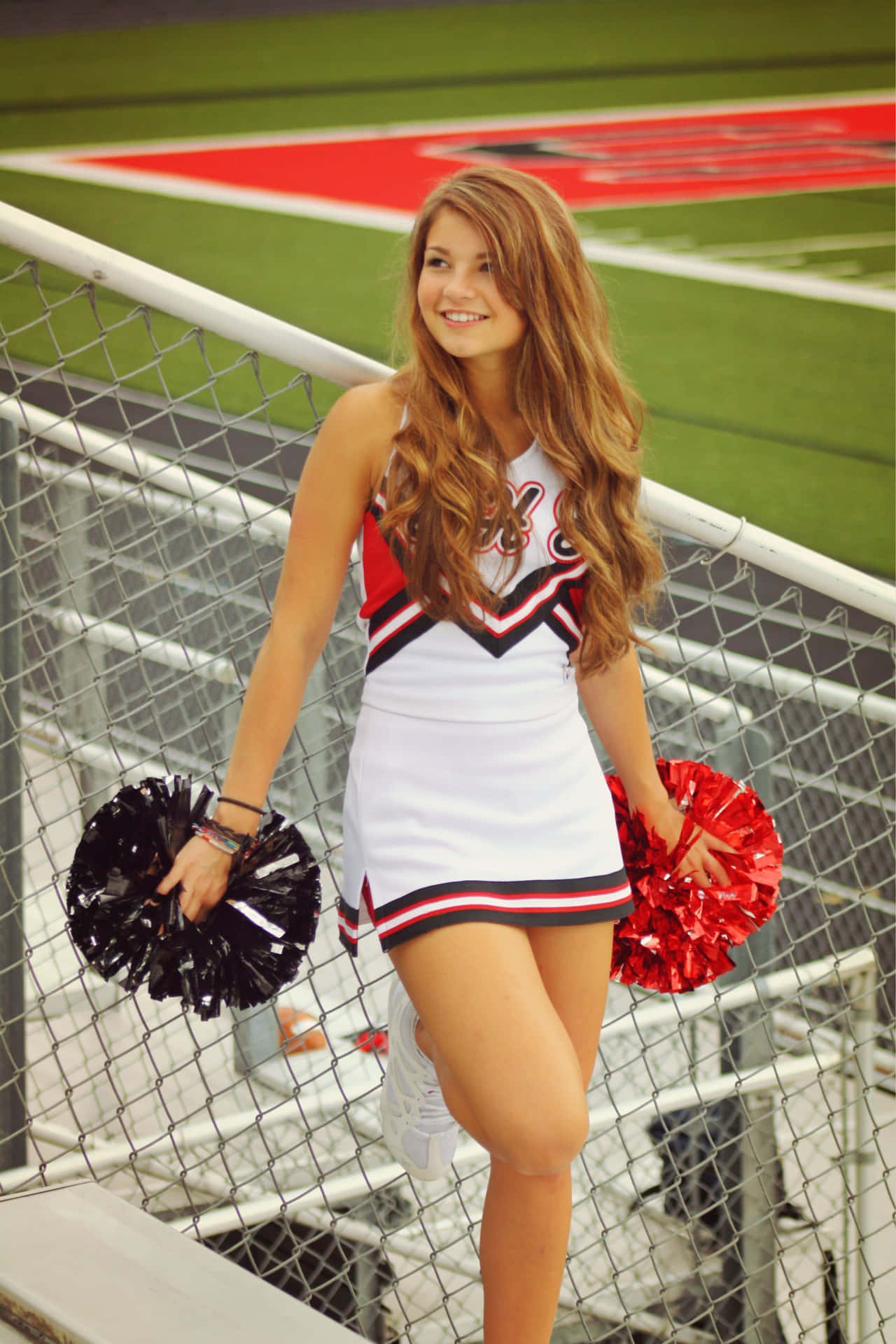 Cheerleader Standing On Railing Picture