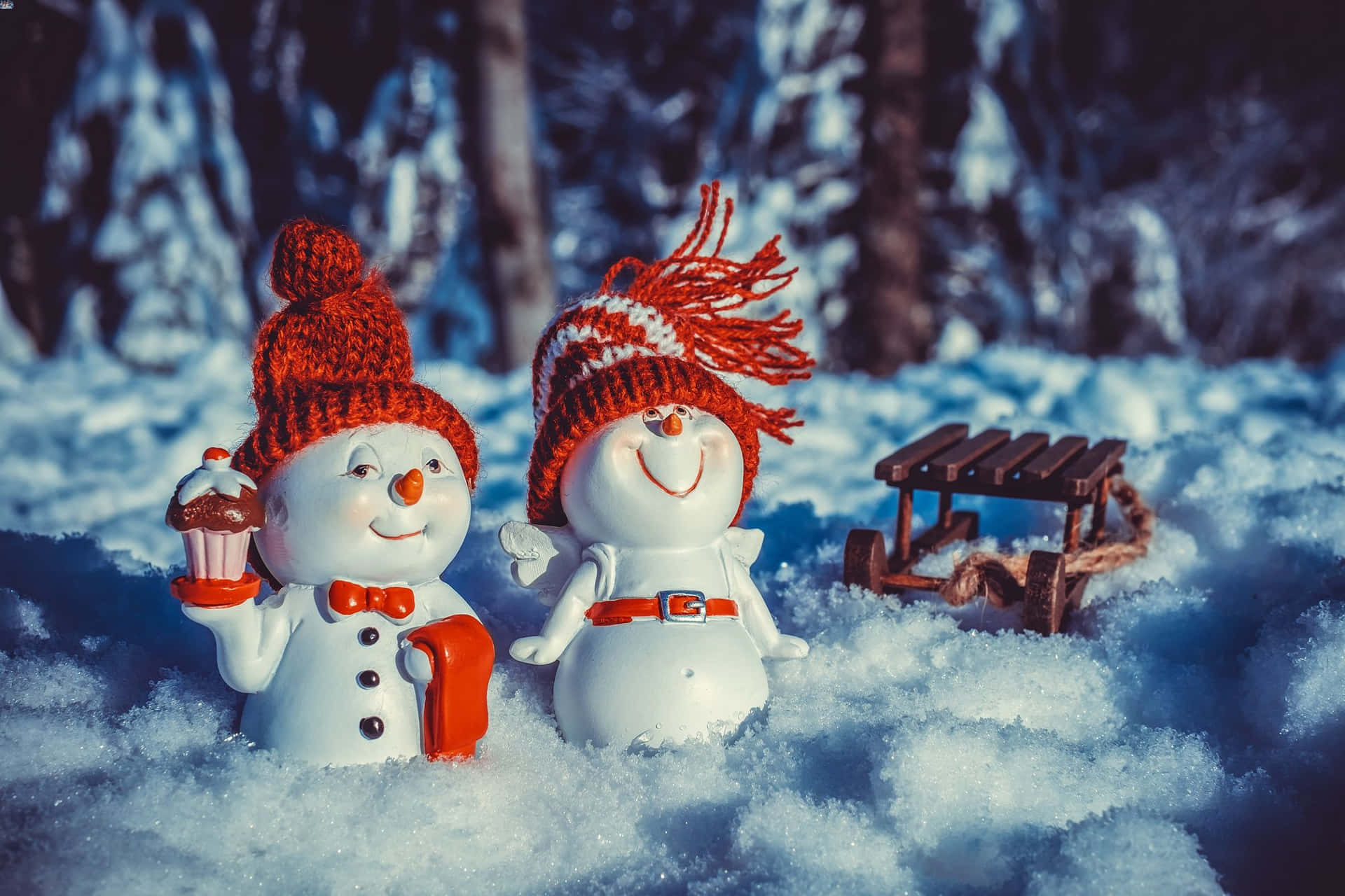 Cheerful Snowmen With Sled Winter Scene Wallpaper