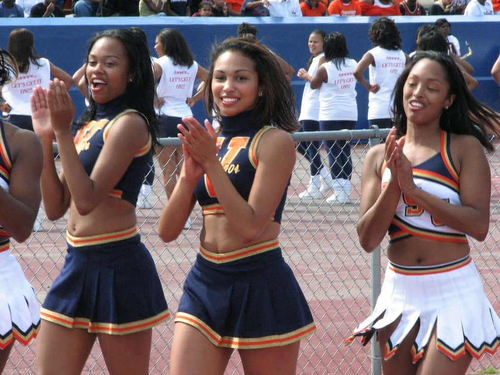 Cheerleaders Performing At Sporting Event Wallpaper