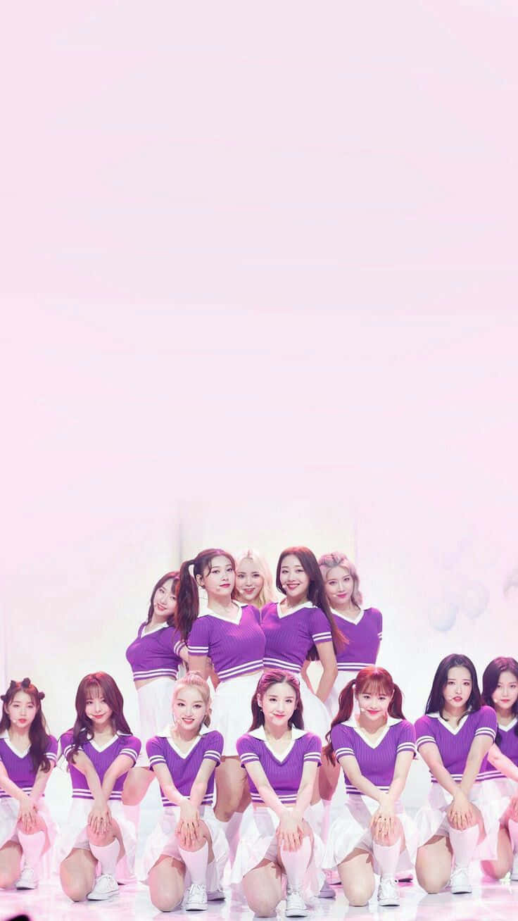 Cheerleading Team_ Purple Uniforms_ Pink Background Wallpaper