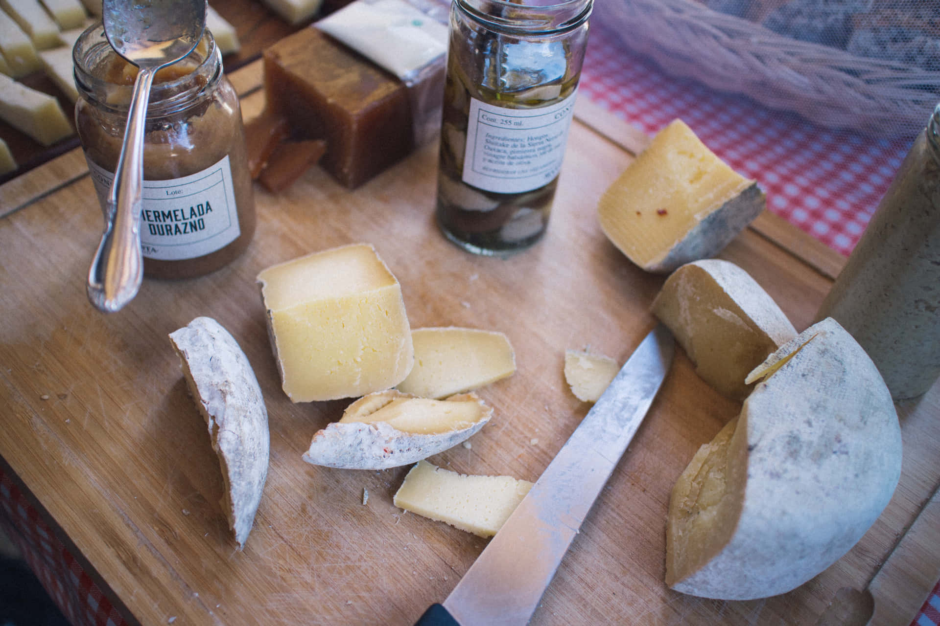 A vibrant display of various types of cheese on a wooden cutting board
