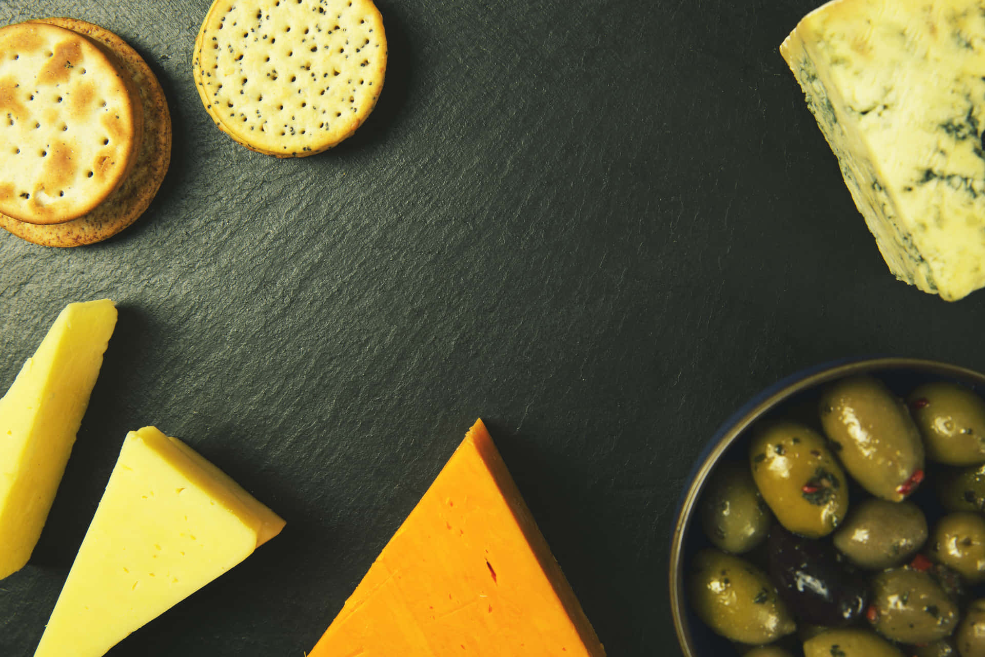 Assortment of delicious cheese on rustic wooden board