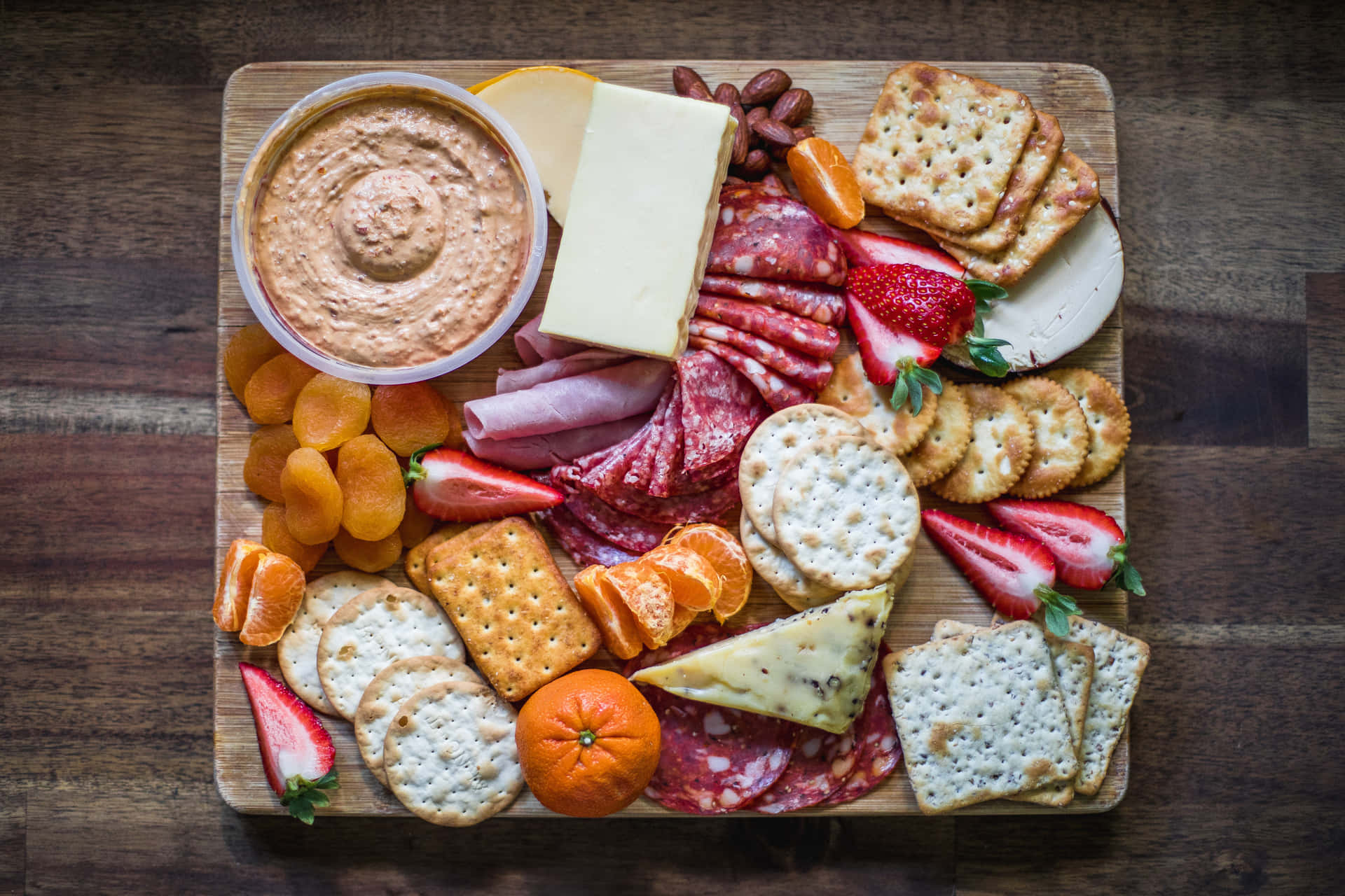 A vibrant assortment of delicious cheeses on a rustic wooden table.