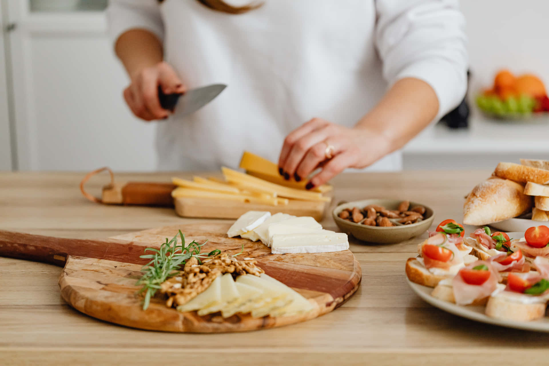 A variety of delicious artisan cheeses displayed on a rustic wooden board