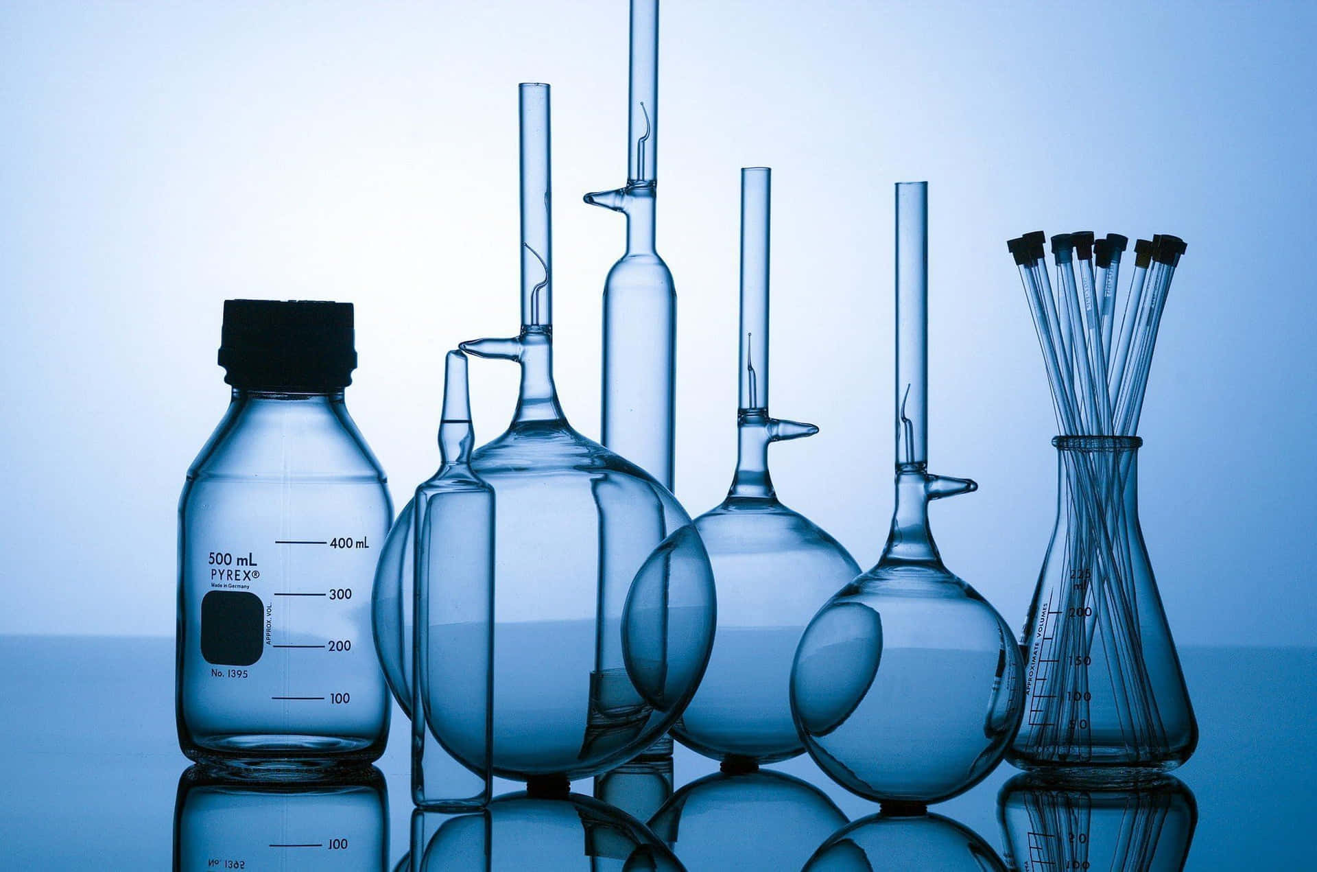 A Group Of Laboratory Glassware On A Blue Background