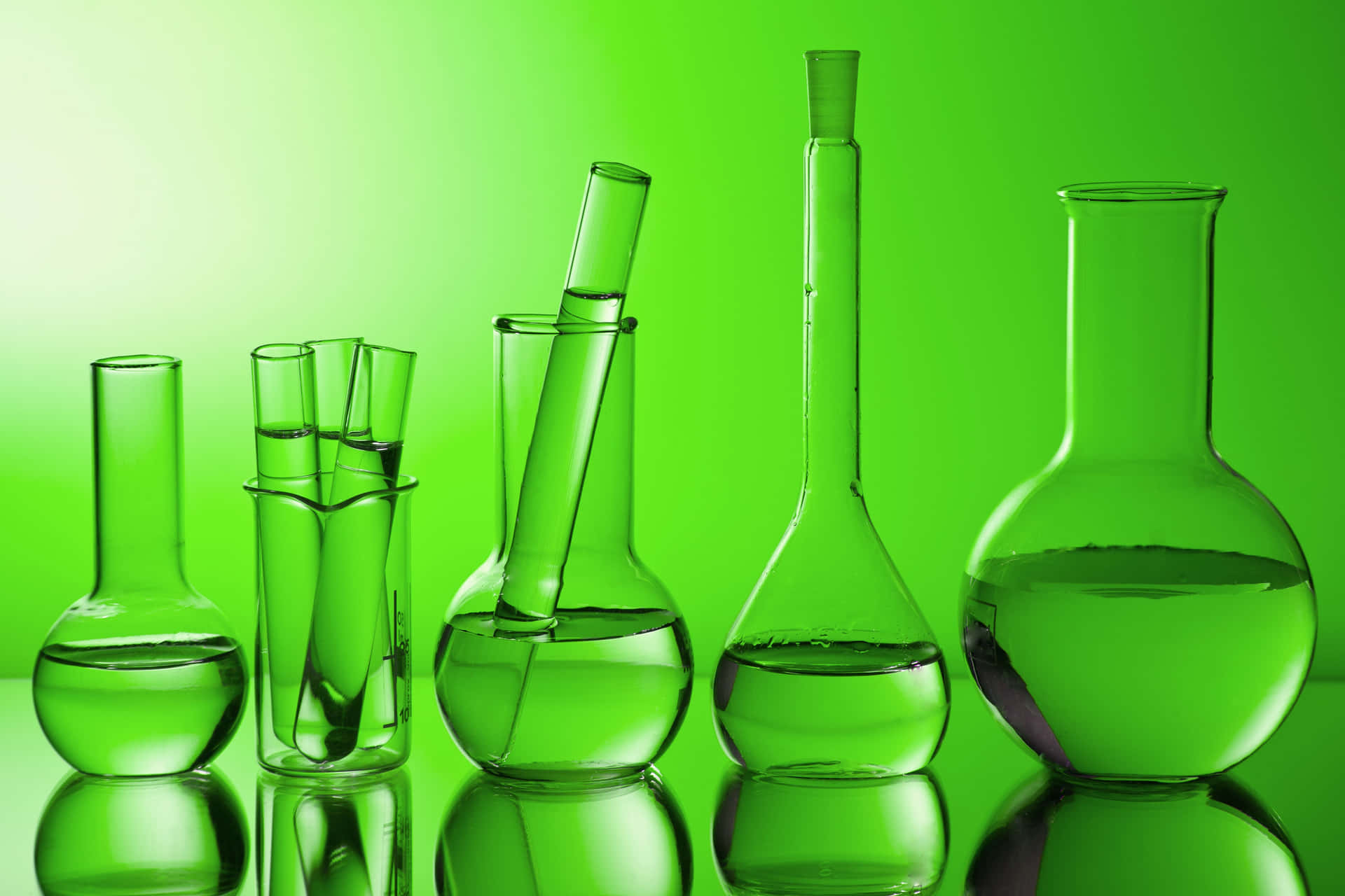 Green Laboratory Glassware On A Green Background