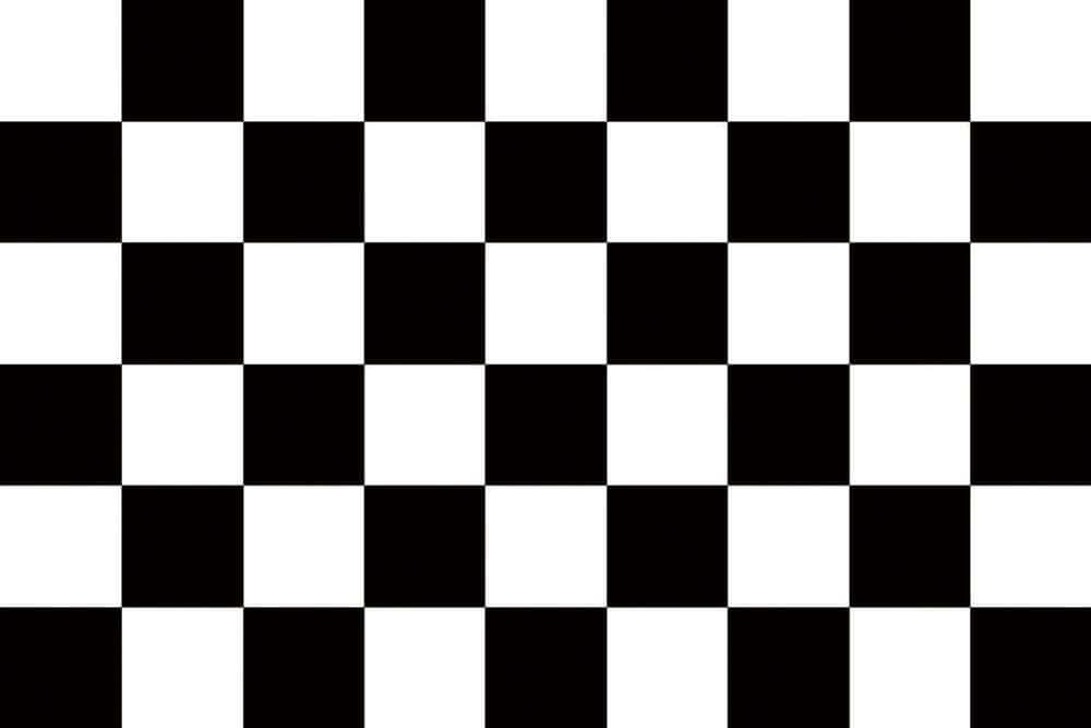 Chequered Flag Waving at a Motorsports Finish Line Wallpaper