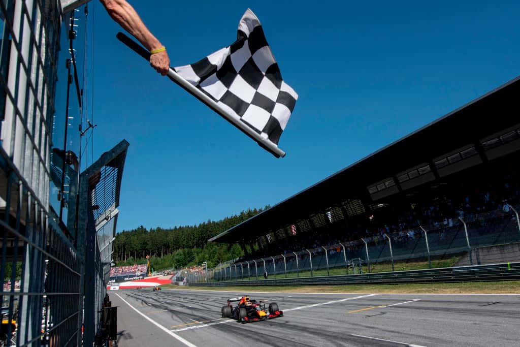 Chequered Flag Waving at Finish Line Wallpaper