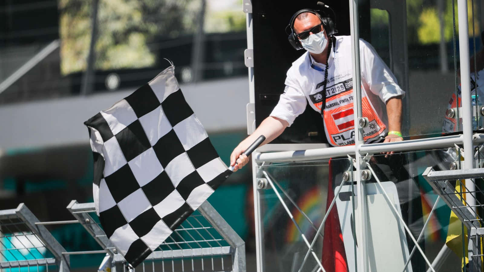 Chequered Flag Waving at Finish Line Wallpaper