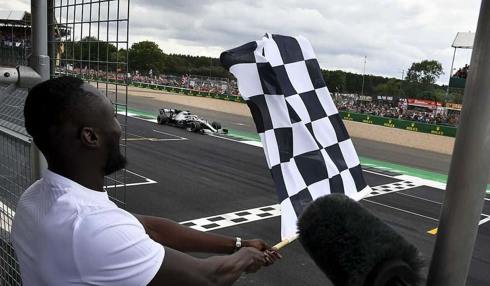 Chequered flag waving proudly in the wind Wallpaper