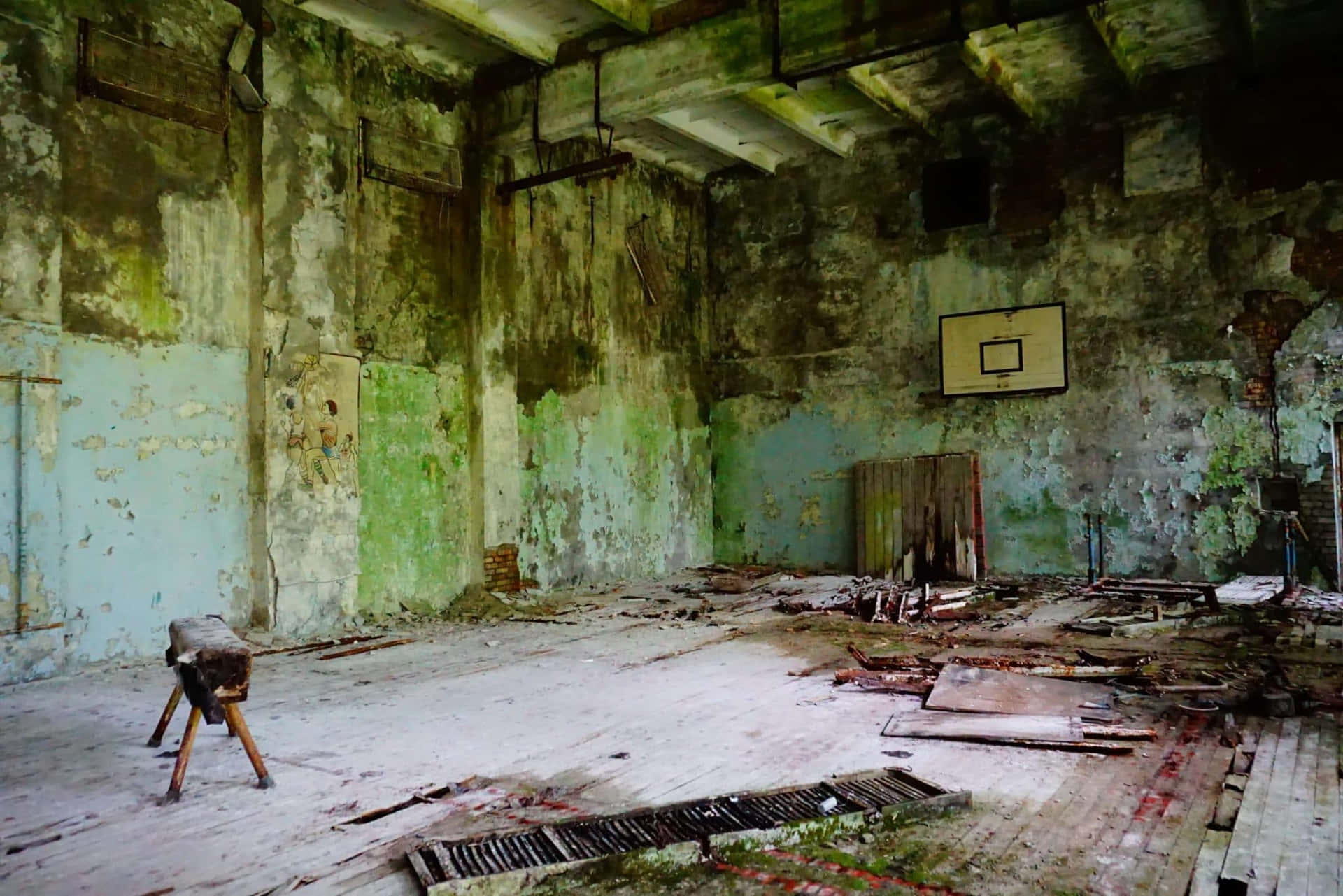 An Abandoned Basketball Court With A Wooden Floor
