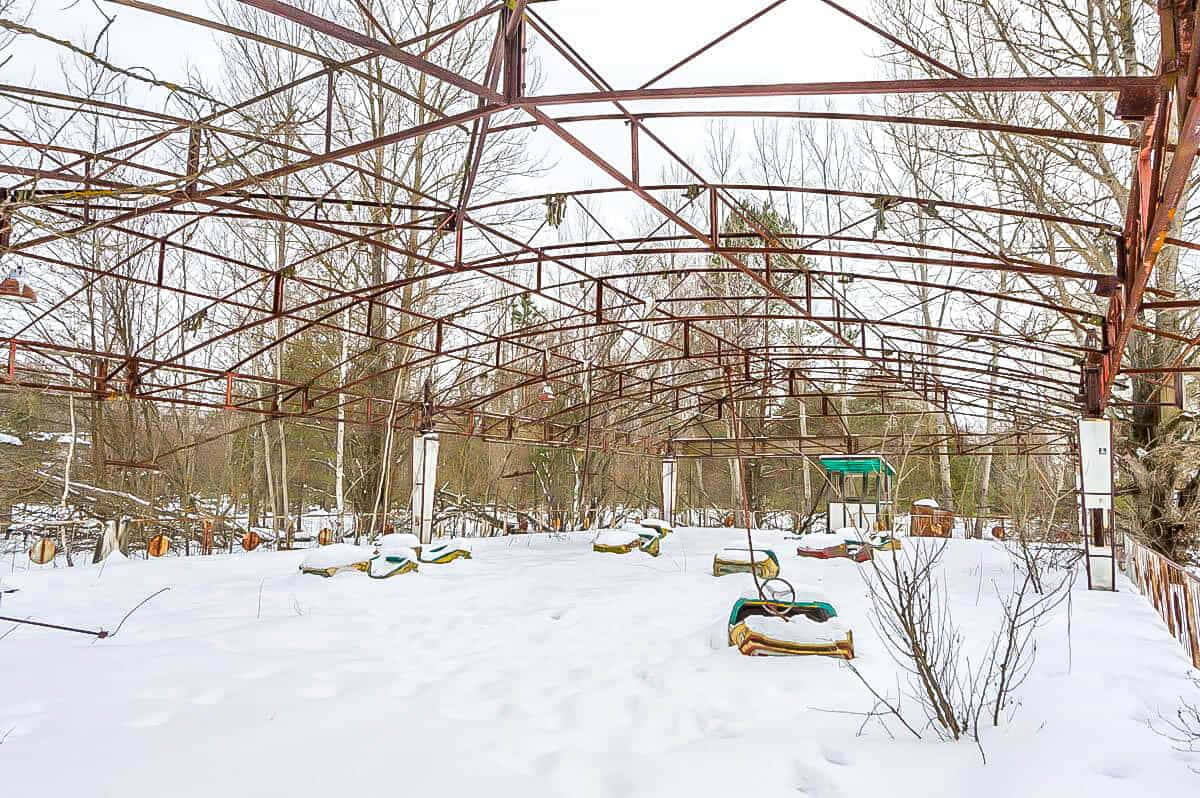 A Rusted Metal Structure With A Snow Covered Floor