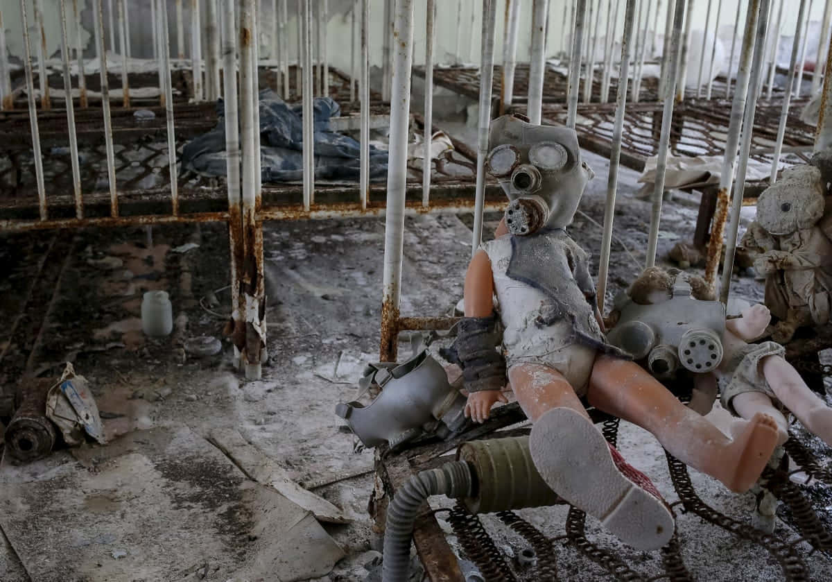 A Group Of Dolls Sitting In A Room With Gas Masks