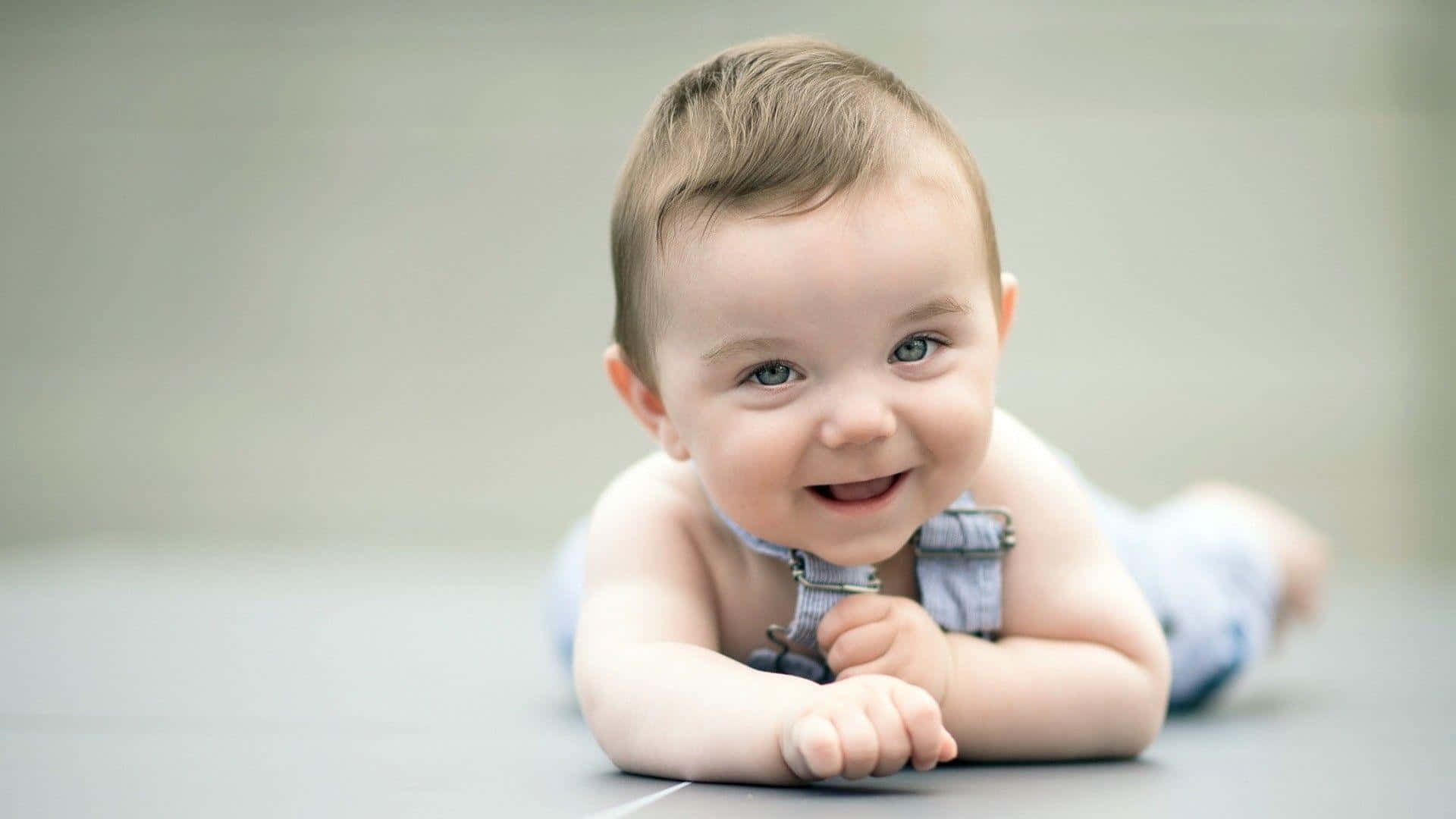 "cherubic Delight: An Adorable Baby Smiling In Pure Joy"