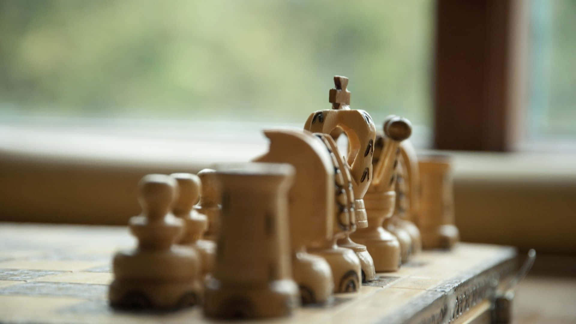 Chess Pieces On A Table With A Window