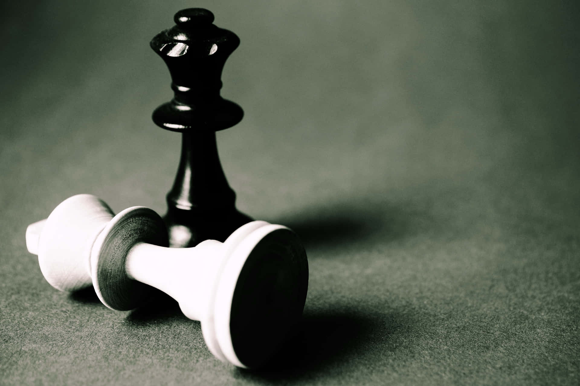 A Black And White Chess Piece Is Sitting On A Gray Background