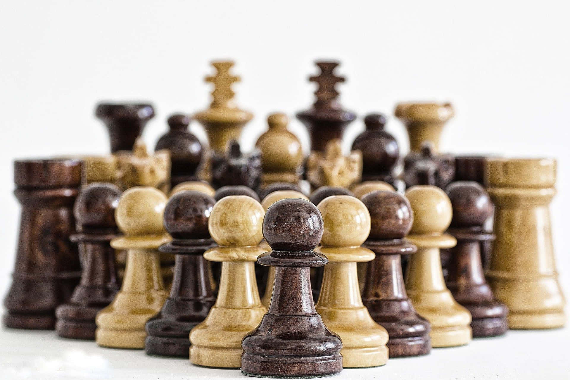 A Group Of Wooden Chess Pieces On A White Background