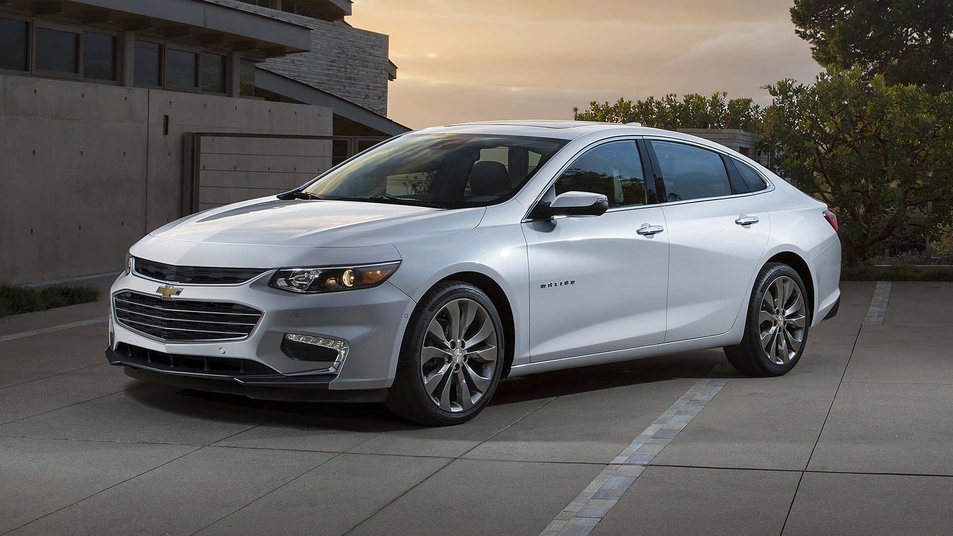 The 2019 Chevrolet Malibu Is Parked In Front Of A Building Wallpaper