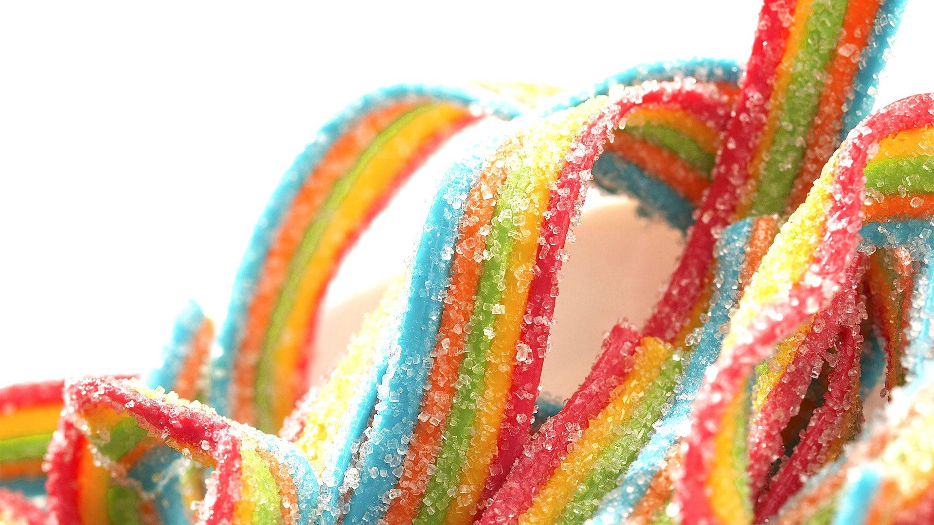 Dulcesde Azúcar Masticables En Colores Del Arcoíris. Fondo de pantalla