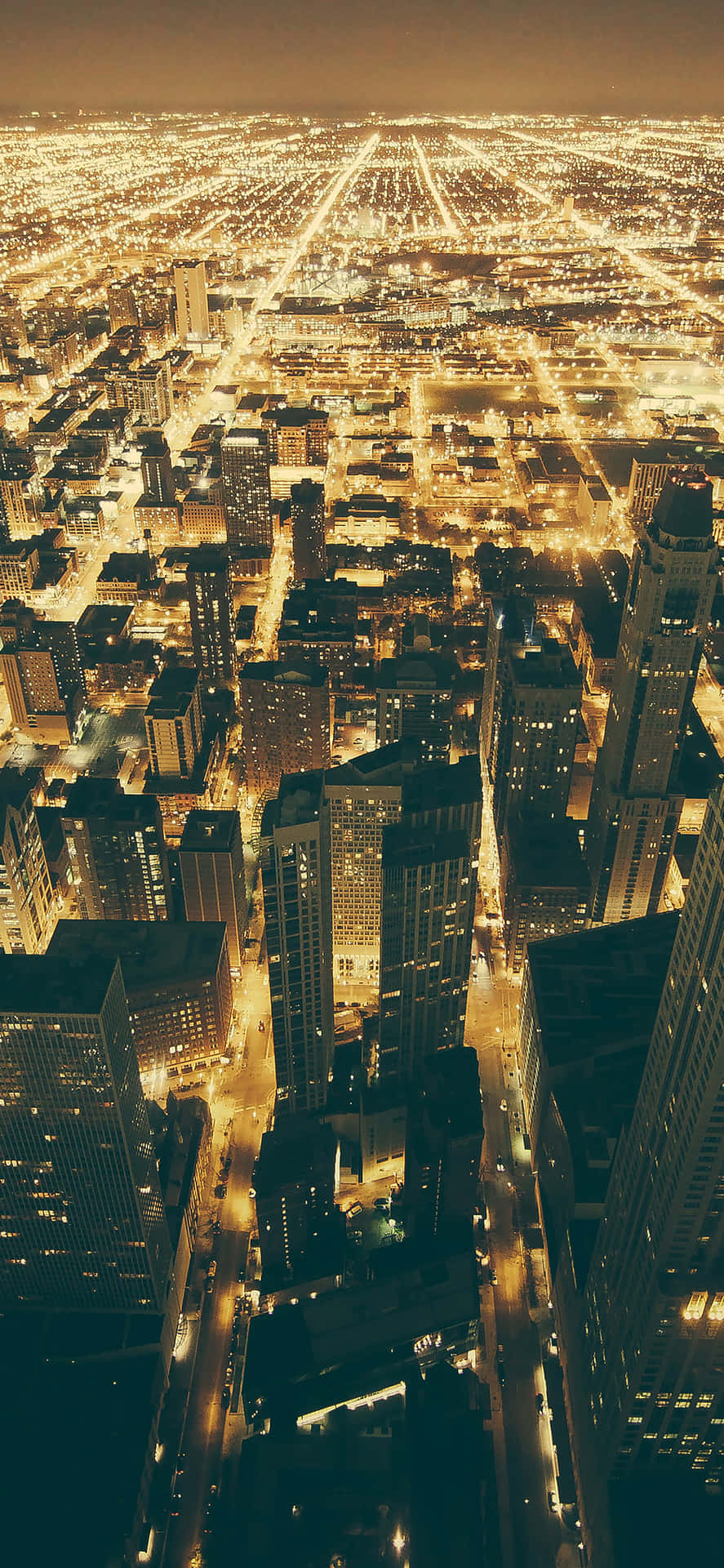 Glitrende lys oplyser Chicago By om natten Wallpaper