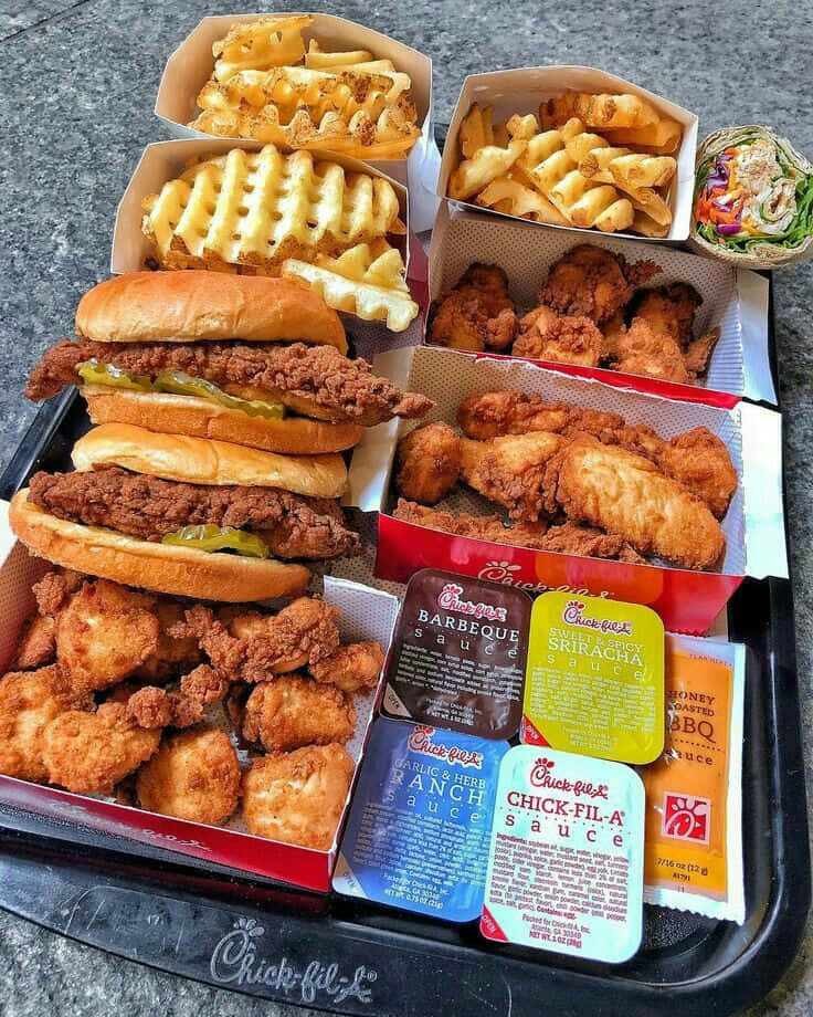 A Tray Of Chicken, Fries And A Soda